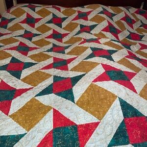 Geometric Patterned Quilt in Red, Gold, and Green